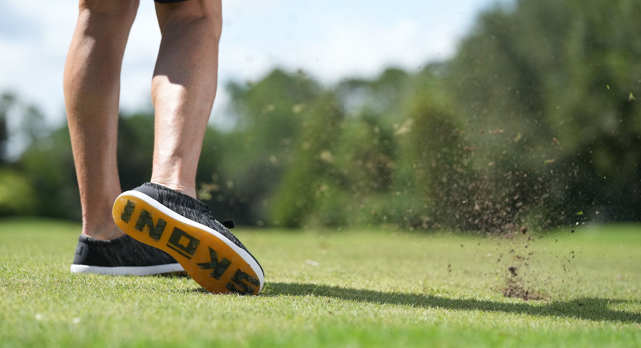 Comfortable shoes by SKŌNI worn on golf course